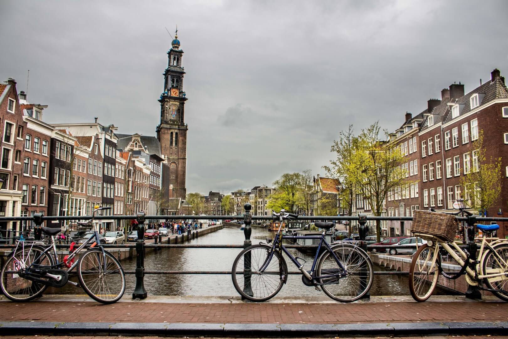 beautiful-shot-of-bicycles-leaned-again-the-fence-on-bridge-over-the-river